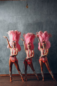 Full length portrait of man with arms raised