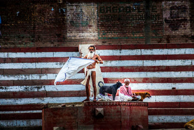 Digital composite image of people on wall