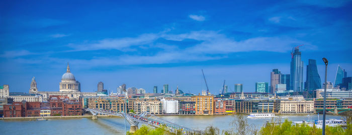 Buildings in city against cloudy sky