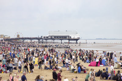 Crowd on beach against sky at cleethorpes