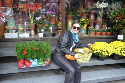 Full length of young man by potted plant