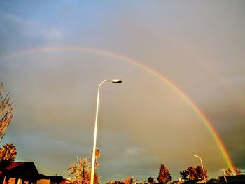 Low angle view of rainbow over trees