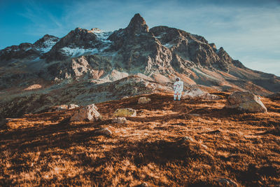 Astronaut standing on land against mountain