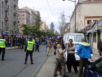 People walking on road along buildings