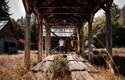Man standing at abandoned hut 