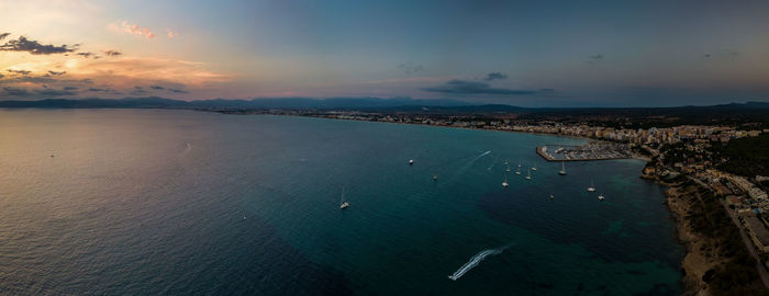 High angle view of sea shore against sky during sunset