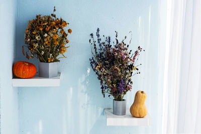 Autumn still life. pumpkins and dried flowers. modern fall concept in minimalism style.