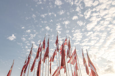 Low angle view of flags against sky