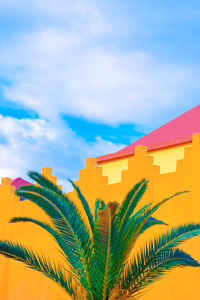 Fashion tropical urban location. yellow wall. palm. blue summer sky. canary islands. travel 