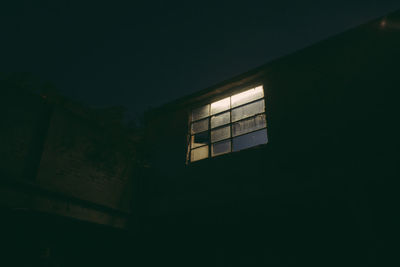 Low angle view of illuminated building against sky at night