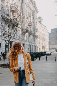 Rear view of woman standing in city