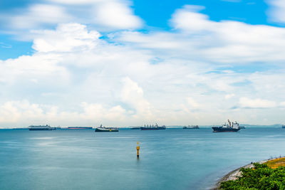 Boats sailing in sea against sky