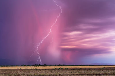 A dramatic lightning strike at sunset from a monsoon storm near tucson, arizona