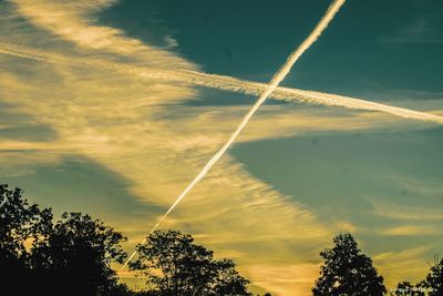 Low angle view of vapor trails in sky