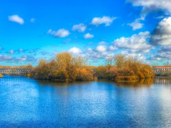 Scenic view of lake against blue sky