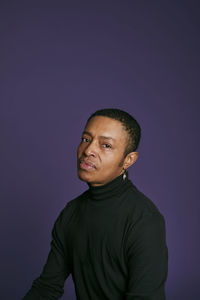 Portrait of young man against gray background