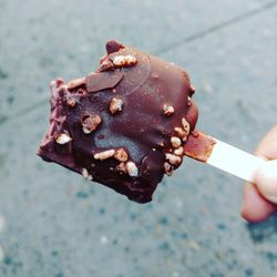 Close-up of hand holding ice cream cone