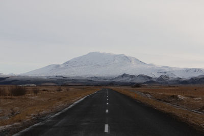 Road amidst mountains against sky