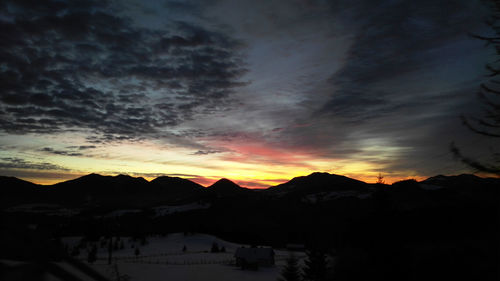 Scenic view of silhouette mountains against sky during sunset