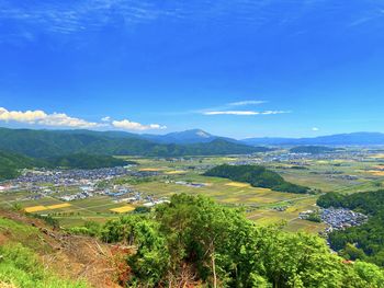 Scenic view of landscape against blue sky