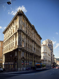 View of city street and buildings against sky