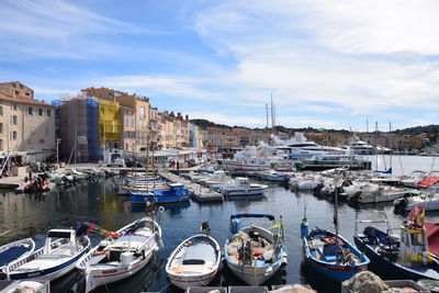 High angle view of boats moored at harbor in city