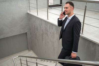 Businessman walking on staircase