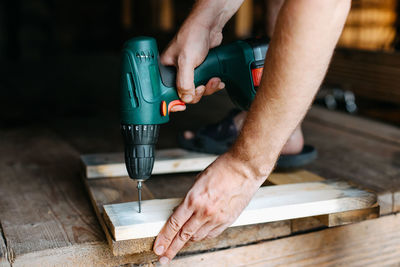 Midsection of man working in workshop