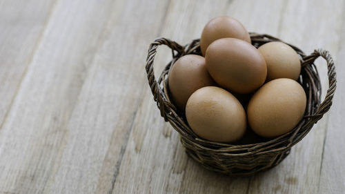 High angle view of eggs in basket on table