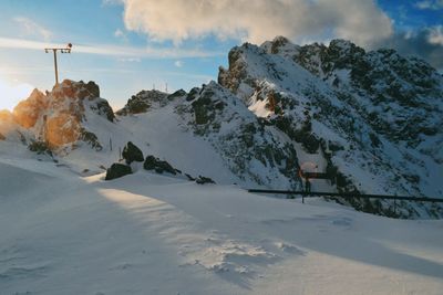 Scenic view of snow covered mountains against sky