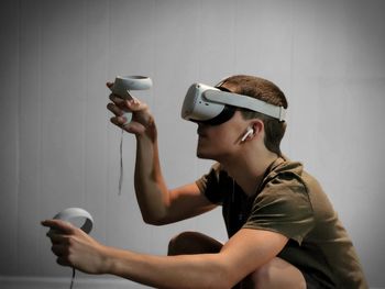 Side view of teenager playing with vr