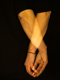 Close-up of human hand against black background