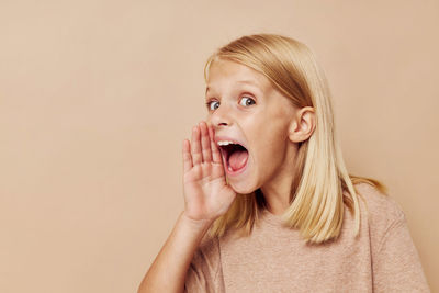 Portrait of young woman against pink background