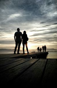 People on beach at sunset