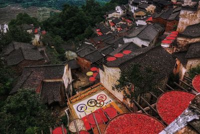 High angle view of red chili peppers in wicker containers on house roofs