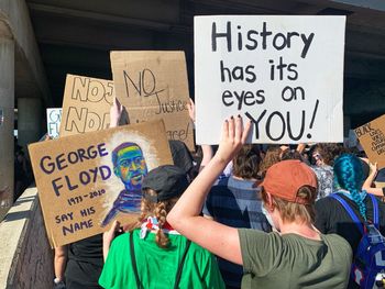 Blm protestors holding george floyd sign