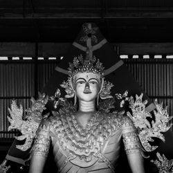 Portrait of buddha statue against building