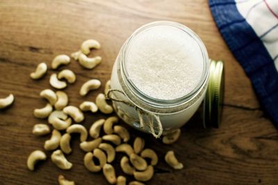 Drink in mason jar on table with cashew nuts
