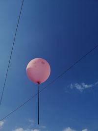 Low angle view of balloons against blue sky