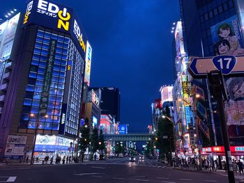 Illuminated city street and buildings at night