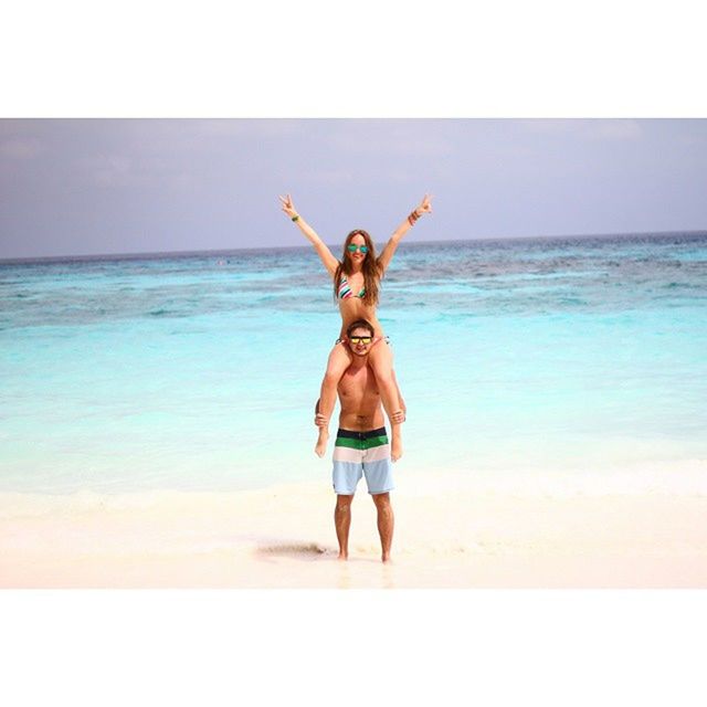 sea, horizon over water, water, full length, beach, leisure activity, lifestyles, young adult, enjoyment, person, fun, vacations, young women, shirtless, arms raised, jumping, happiness, arms outstretched