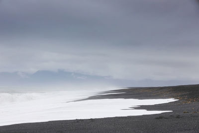 Road by sea against sky