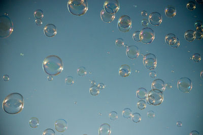 Full frame shot of bubbles flying against sky