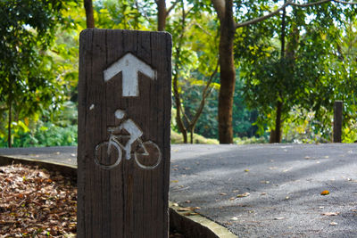 Close-up of road sign against trees