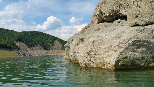 Scenic view of rocks in water against sky