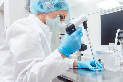 Side view of scientist doing experiment in laboratory