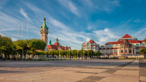 View of buildings in city against cloudy sky