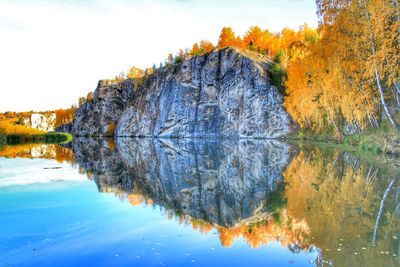 Reflection of trees in lake against sky during autumn