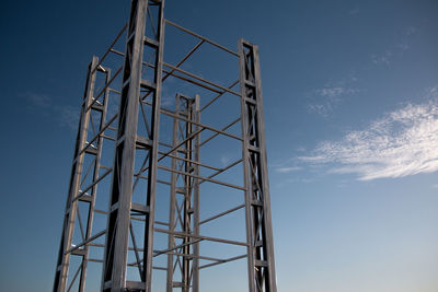 Low angle view of tower against blue sky