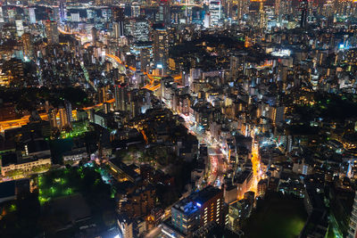 High angle view of illuminated city buildings at night